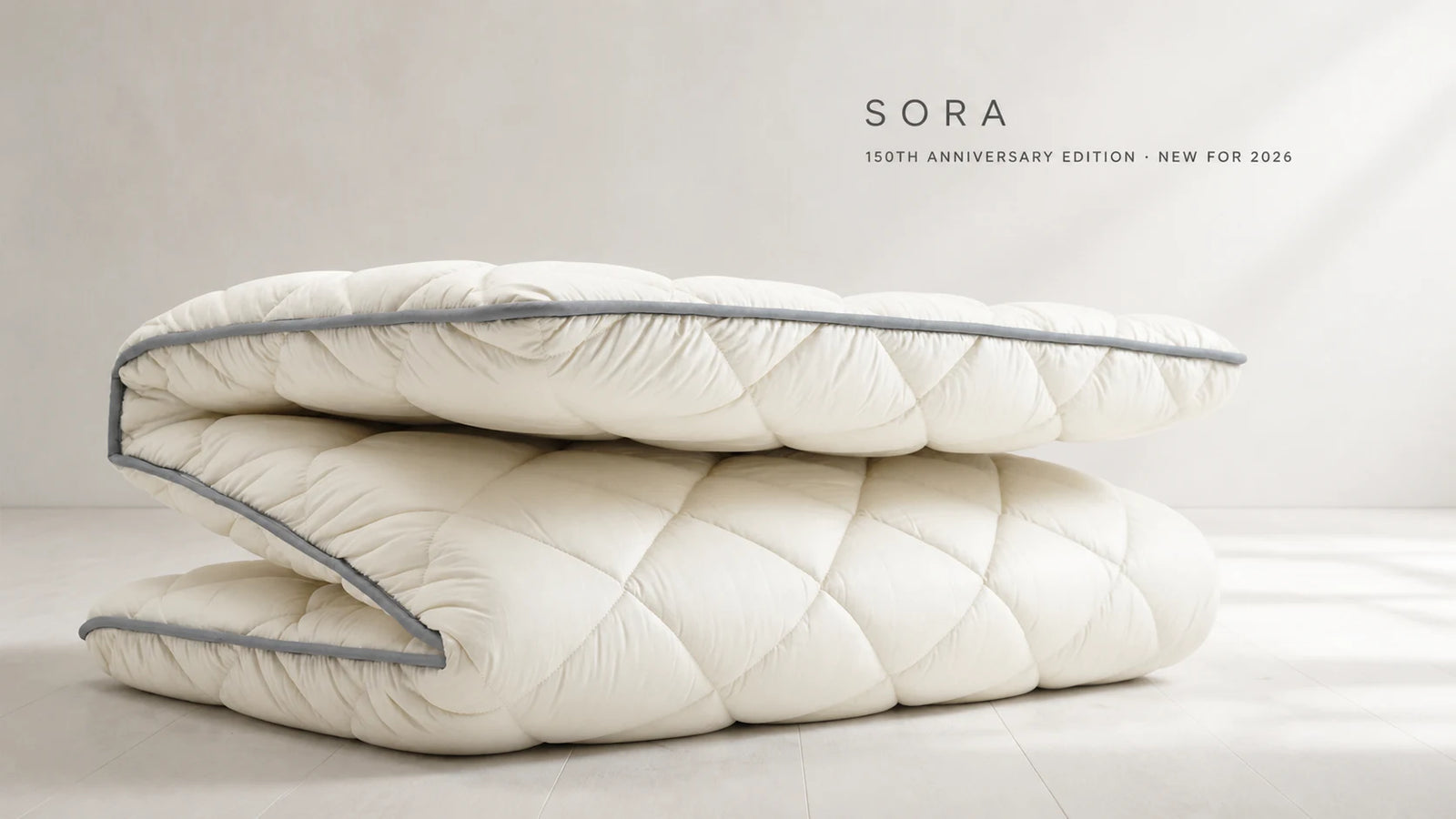 SORA 150th Anniversary Limited Edition folded in three, showing its generous loft and calm gray piping